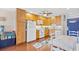 Bright kitchen with white appliances, wooden cabinets, and a nautical-themed table at 5601 N Ocean Blvd. # C-311, Myrtle Beach, SC 29577