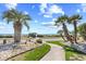 Lush landscaping and palm trees leading to beach access, creating a tropical paradise at 5601 N Ocean Blvd. # C-311, Myrtle Beach, SC 29577