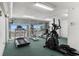 Well-equipped gym with treadmills and stationary bikes, featuring scenic views of the ocean and beach at 5700 N Ocean Blvd. # 1107, North Myrtle Beach, SC 29582