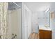Bathroom featuring a shower, large closet with mirrored doors, and vanity with a sink at 600-B 43Rd Ave. S, North Myrtle Beach, SC 29582