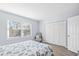 Comfortable bedroom with a chair, closet with folding doors, and bright natural light streaming through the window at 600-B 43Rd Ave. S, North Myrtle Beach, SC 29582