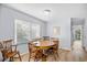 Bright dining area with a wooden table, six chairs, and natural light from the window at 600-B 43Rd Ave. S, North Myrtle Beach, SC 29582