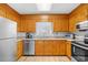 Functional kitchen features wood cabinets, granite countertops, and stainless-steel appliances at 600-B 43Rd Ave. S, North Myrtle Beach, SC 29582