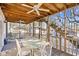 Inviting covered porch with ample seating, a dining table, and stairs leading to the upper levels at 600-B 43Rd Ave. S, North Myrtle Beach, SC 29582