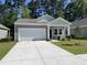 Charming single-story home with attached garage, well-manicured lawn, and mature trees at 639 Muster Field Ct., Conway, SC 29526