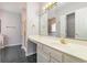 Bathroom featuring a large mirror, vanity, and walk-in shower with black tile floors at 640 Intracoastal Way # 640, Myrtle Beach, SC 29579