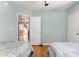 Bedroom featuring twin beds, wood floors, and a doorway that leads to a porch at 640 Intracoastal Way # 640, Myrtle Beach, SC 29579