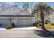 Charming villa with a pristine white facade, garage, and lush palm trees at 640 Intracoastal Way # 640, Myrtle Beach, SC 29579