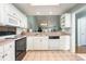 Bright kitchen with white cabinets, tile flooring, and a seamless view to the living area at 640 Intracoastal Way # 640, Myrtle Beach, SC 29579