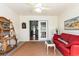Bright sunroom with white shiplap walls, red couch, and access to the main house at 640 Intracoastal Way # 640, Myrtle Beach, SC 29579