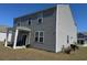 This home's back exterior features a covered patio, well-kept lawn, and durable siding at 645 Black Pearl Way, Myrtle Beach, SC 29588