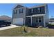 Inviting two-story home with a covered porch, neat landscaping, and attached two-car garage at 645 Black Pearl Way, Myrtle Beach, SC 29588