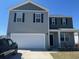 Charming two-story home featuring a two-car garage, classic shutters, and a well-maintained lawn at 645 Black Pearl Way, Myrtle Beach, SC 29588