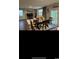 Open-concept living area with hardwood floors, ample natural light, and elegant dining set at 645 Black Pearl Way, Myrtle Beach, SC 29588