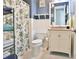Well-lit bathroom featuring a vanity, toilet, shower curtain, and tile floors at 676 Johnson Ave., Myrtle Beach, SC 29577