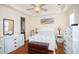 Bright bedroom with hardwood flooring, ceiling fan, coastal artwork and neutral colored furniture at 676 Johnson Ave., Myrtle Beach, SC 29577