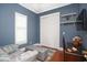 Blue bedroom featuring a comfortable chair, ottoman, and desk at 676 Johnson Ave., Myrtle Beach, SC 29577