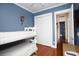 Blue bedroom featuring a bunk bed, closet, and wood floors at 676 Johnson Ave., Myrtle Beach, SC 29577