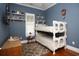 Cozy bedroom with hardwood flooring, bunk beds, a window and blue colored walls at 676 Johnson Ave., Myrtle Beach, SC 29577