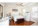 Bright bedroom with light walls and hardwood flooring, ceiling fan and neutral colored furniture at 676 Johnson Ave., Myrtle Beach, SC 29577