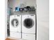 Laundry room with white washer and dryer and storage shelves at 676 Johnson Ave., Myrtle Beach, SC 29577