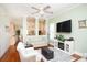Comfortable living room includes a ceiling fan, tv, and hardwood floors at 676 Johnson Ave., Myrtle Beach, SC 29577