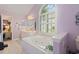 Spacious bathroom with double vanities, a soaking tub, and ample natural light at 6904 Gina Ct., Myrtle Beach, SC 29588