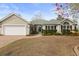 Charming single-story home with manicured landscaping, brick walkway, and attached two-car garage at 6904 Gina Ct., Myrtle Beach, SC 29588