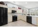Bright kitchen featuring white cabinetry, tile flooring, stainless appliances, and expansive countertop at 6904 Gina Ct., Myrtle Beach, SC 29588