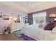 Cozy main bedroom with tray ceiling, light-purple walls, and plenty of natural light at 6904 Gina Ct., Myrtle Beach, SC 29588