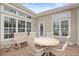 Enclosed patio featuring an outdoor table with chairs and a bench with windows all around at 6904 Gina Ct., Myrtle Beach, SC 29588