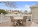 Outdoor patio with a round table and four chairs set on brick pavers within a white picket fence at 6904 Gina Ct., Myrtle Beach, SC 29588
