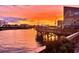 Waterfront view with buildings, a boardwalk, and other waterfront features at sunset at 6904 Gina Ct., Myrtle Beach, SC 29588