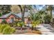 Beautiful brick home featuring manicured landscaping, a garden, and a spacious driveway at 74 Dornoch Dr., Pawleys Island, SC 29585
