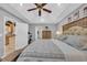 Serene primary bedroom showcasing a king-size bed, a ceiling fan, and ample natural light at 74 Dornoch Dr., Pawleys Island, SC 29585