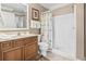 Well-lit bathroom featuring a shower, toilet, and vanity with stylish wooden cabinets at 77 Tern Pl. # 202, Pawleys Island, SC 29585