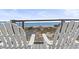 Relaxing beach view from the deck with Adirondack chairs overlooking the dunes and ocean at 77 Tern Pl. # 202, Pawleys Island, SC 29585