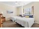 Bright bedroom featuring two beds, neutral walls, carpet and a ceiling fan at 77 Tern Pl. # 202, Pawleys Island, SC 29585