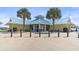 Exterior view of building facade featuring palm trees and modern architecture at 77 Tern Pl. # 202, Pawleys Island, SC 29585