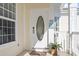 The front door with glass detail is next to a bay window at 77 Tern Pl. # 202, Pawleys Island, SC 29585