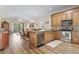 Open-concept kitchen flows into the dining and living areas, featuring stainless appliances and granite countertops at 77 Tern Pl. # 202, Pawleys Island, SC 29585