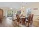Inviting living room with hardwood floors, modern furnishings and bright natural light with access to a balcony at 77 Tern Pl. # 202, Pawleys Island, SC 29585