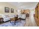 The open-concept living room features hardwood floors and a cozy seating area at 77 Tern Pl. # 202, Pawleys Island, SC 29585