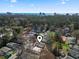 Wide aerial shot showcasing neighborhood homes near the ocean and city, marked with a location pin at 909 Pine Thicket St., Myrtle Beach, SC 29577