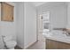 Bright bathroom features a toilet, cabinet, and double sink vanity adjacent to a bedroom at 909 Pine Thicket St., Myrtle Beach, SC 29577