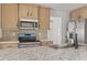 Close-up of kitchen with stainless appliances, gray countertops, and light cabinets at 909 Pine Thicket St., Myrtle Beach, SC 29577