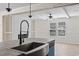 Bright kitchen featuring a stainless steel farmhouse sink and fixtures at 909 Pine Thicket St., Myrtle Beach, SC 29577
