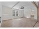 Living room with wood floors, white walls, ceiling fan, and large windows at 909 Pine Thicket St., Myrtle Beach, SC 29577