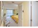 Bedroom featuring two beds with white furniture, an office chair, and balcony access at 9820 Queensway Blvd. # 1210, Myrtle Beach, SC 29572