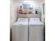 Efficient laundry room features a washer, dryer, and storage shelves, providing convenience and organization at 9820 Queensway Blvd. # 1210, Myrtle Beach, SC 29572
